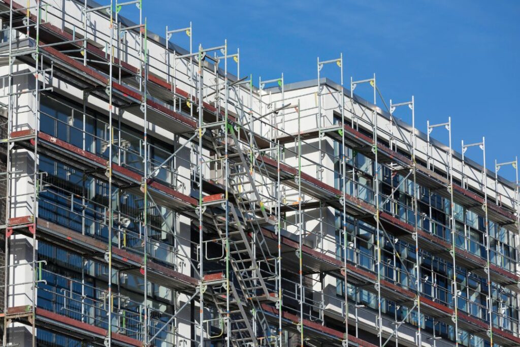 Rusztowania fasadowe przy kotwiczone kotwami do elewacji bloku wielorodzinnego mieszkalnego
